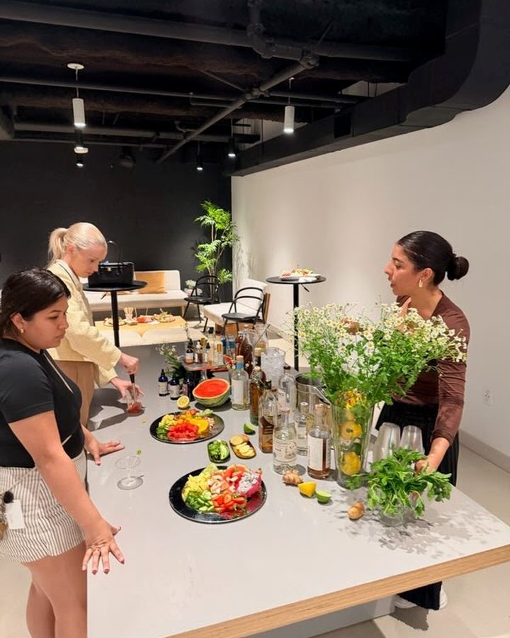 The Natural Mixologist team setting up a cocktail station with fresh produce and flowers